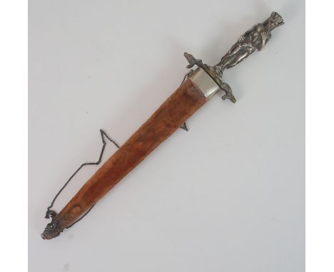 A 20TH CENTURY DECORATIVE DAGGER the 18cm long diamond section blade with white metal hilt modelled as a mythical figure, the