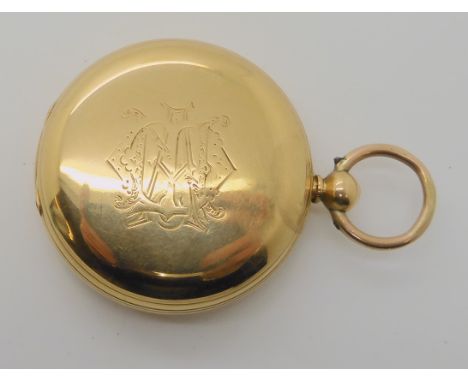 AN 18CT GOLD FULL HUNTER POCKET WATCH has a plain case with a monogram to one side, with a white enamelled dial, black Roman 