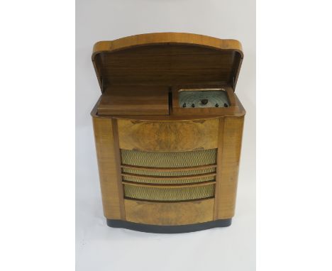 A VINTAGE DYNATRON ETHER CONQUEROR, K129 RADIOGRAM in bow fronted walnut case, with maker plaque on the back, 85 x 44 x 87cm 