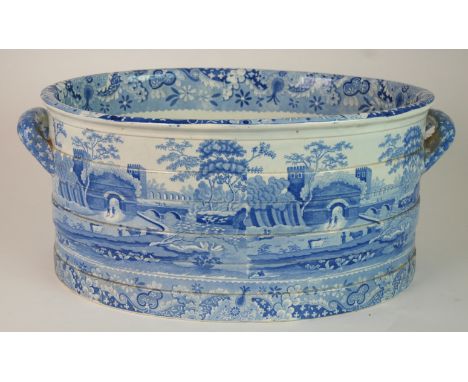 A SPODE BLUE AND WHITE TRANSFER PRINTED CASTLE PATTERN FOOT BATH of oval form with two handles, printed mark to base, 47cm lo