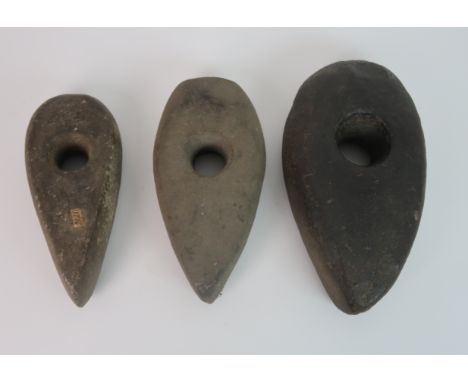 THREE ANCIENT BRITISH STONE CARVED AXE HEADS 22cm, 25cm and 21cm long The estate of The late Robert and Lyndsay Brydon, Edinb