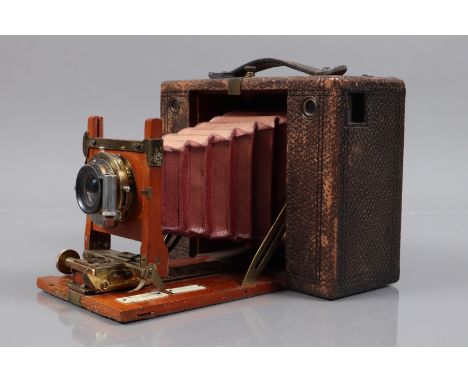 A Kodak No 4 Folding Bed Camera, shutter erratic, red bellow faded, F, body F-G, wear to leatherette, elements F, fungus to r