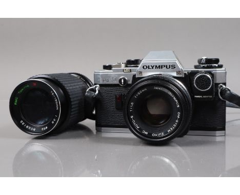 An Olympus OM-10 SLR Camera,  shutter working, meter responsive, self timer working, body G-VG,  with manual adapter, Zuiko 5