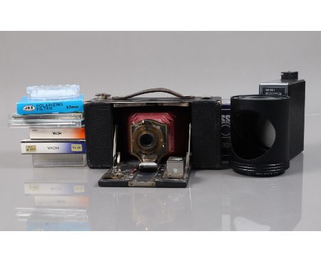 A Kodak No2 Folding Pocket Brownie Camera, shutter working, body G, bellows G, with some unrelated filters and other items