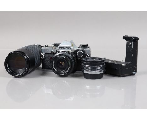 An Olympus OM10 SLR Camera,  serial no 1765537, corrosion to top plate, shutter working, meter reacts to light, viewfinder LE