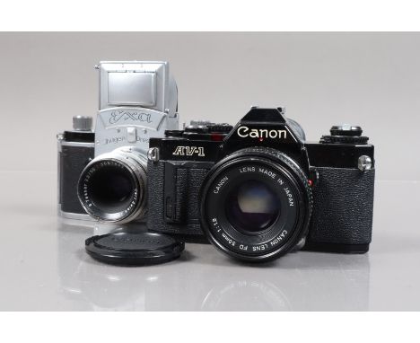 A Black Canon AV-1 and an Exa SLR Cameras, AV-1 serial no 961867, body G, scuffs to base plate, shutter working, meter reacts