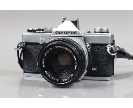 An Olympus OM-1N SLR Camera, serial no 1679671, body F-G, shutter working, meter reacts to light, an OM-System F.Zuiko Auto-S