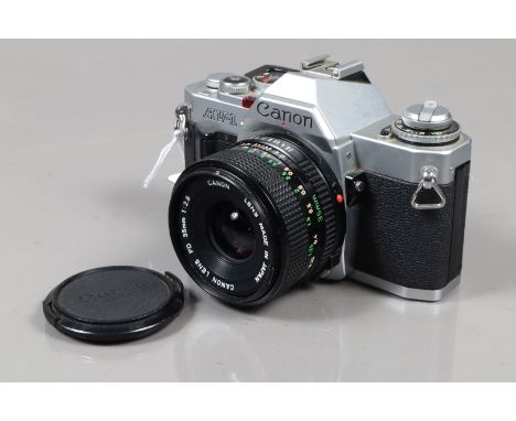 A Canon AV-1 SLR Camera, chrome, serial no 445880, shutter working, meter responsive, self timer working, body G, some wear, 