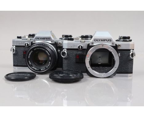 Two Olympus OM10 SLR Cameras, comprising an OM10 serial no 2680858, body F-G, shutter working, meter reacts to light, Zuiko M