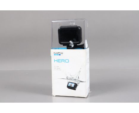 A GoPro Hero Camera, 2018, powers up, appears to function as should, no SD card present, with housing, USB cable, battery, bo