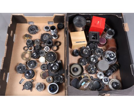 Two Trays of Mid 20th Century Lenses, 30 approx examples of camera, enlarging and other lenses, condition P, some with shutte