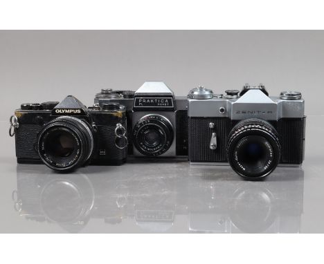 Three SLR Cameras, an Olympus OM-1n, black, shutter working, meter responsive, body F, brassing and wear, with Zuiko 50mm f/1