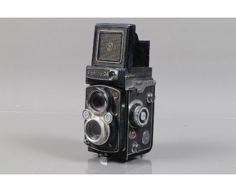 A Yashica 24 TLR Camera, shutter working, meter responsive, body F-G, would benefit from a clean, some wear, with Yashinon 80