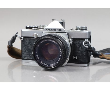 An Olympus OM-1 MD SLR Camera, serial no 1563431, body F, handling marks, owner's label on base plate, shutter working, meter