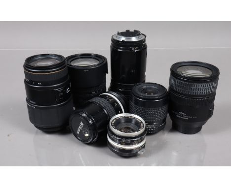 A Group of Nikon Lenses, an AF Nikkor ED 180mm f/2.8 lens, a 35-80mm f/4-5.6D lens, a DX AF-S 18-105mm f/3.5-5.6G ED lens, an