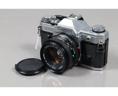 A Canon AT-1 SLR Camera, chrome, serial no 193132, shutter working, meter responsive, self timer working, body G, light wear,