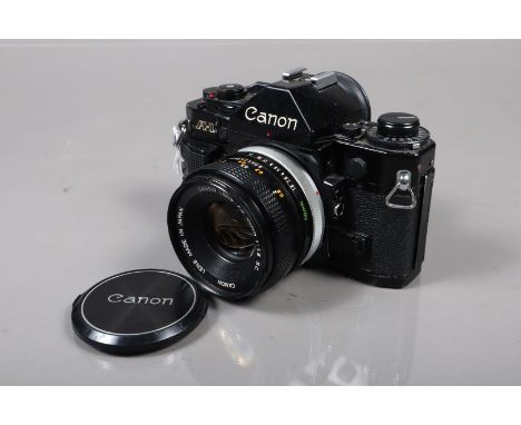 A Canon A-1 SLR Camera, black, serial no 191684, shutter working, meter responsive, self timer working, body G, some wear to 