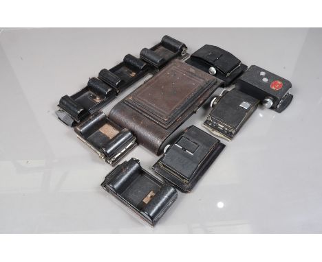 Nine 6 x 9cm Roll Film Backs, comprising a Plaubel Rada back, five Rollex-Patent backs, an L and J back, two other backs, one