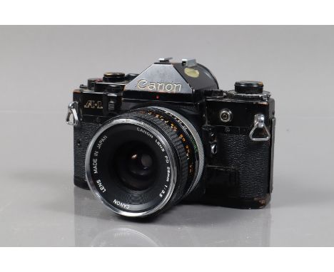 A Canon A-1 SLR Camera, serial no 1848312, shutter working, meter responsive, self timer working, body F-G, brassing to edges