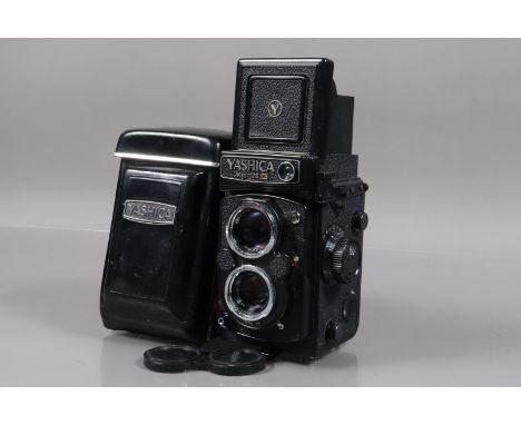 A Yashica MAT 124 G TLR Camera, shutter working, meter responsive, body G-VG, some light paint wear tto edges, with Yashinon 