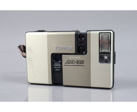 A Konica Auto Focus AA-35 Camera, gold, shutter working, flash working, body G, some scratches to front, in soft case