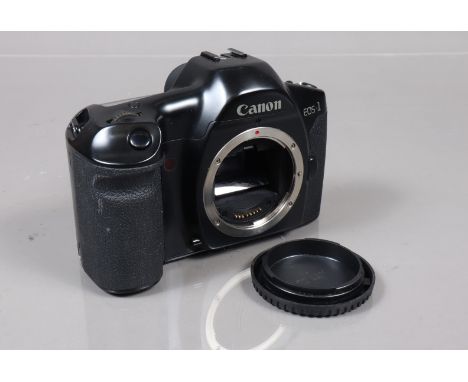 A Canon EOS 1 SLR Camera Body, serial no 180235, powers up, shutter working, appears to function as should, body G, light wea