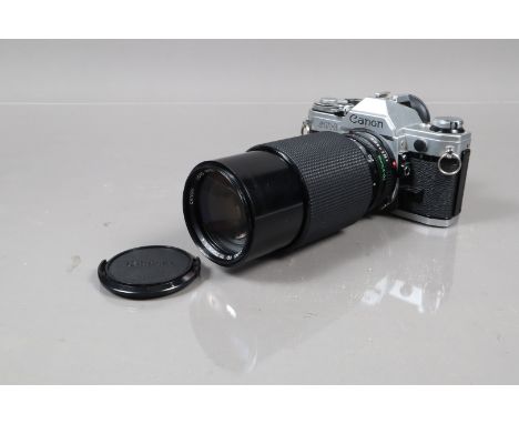 A Canon AE-1 SLR Camera, serial no 4719175, shutter working, meter responsive, self timer working, body G, light wear, with 7
