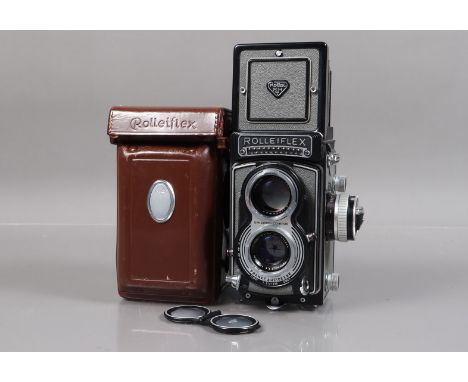 A Rolleiflex T TLR Camera, grey, serial no T 2121590, shutter not working, crank does not stop turning, shutter sometimes fir