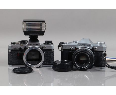 Two Olympus SLR Cameras, an Olympus OM-10, shutter working, meter responsive, self timer working, body G, with Zuiko 50mm f/1