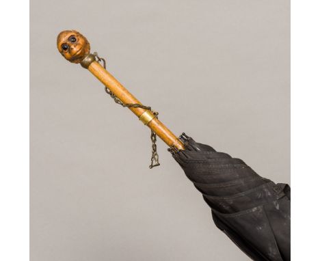 An Edwardian parasol by Brigg of LondonWith monkey mask carved finial and inscribed Hon. Lady McCalmont, 7 Cleveland Row SW. 