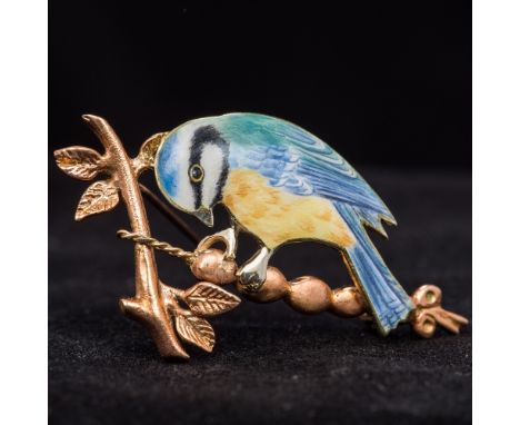 A 9 ct gold enamel decorated broochFormed as blue tit on a branch.  5 cm wide.  CONDITION REPORTS: Generally in good conditio