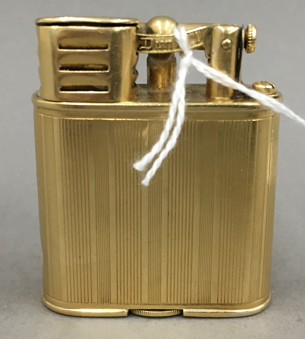 A Dunhill 18 ct gold plated lighter, signed Alfred Dunhill, Paris and ...