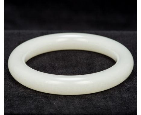 A Chinese mutton fat jade bangleOf typical form.  8 cm diameter.  CONDITION REPORTS: Generally in good condition.
