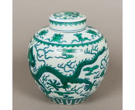 A Chinese porcelain ginger jar and coverWith white ground, decorated in the round with green five clawed dragons chasing a fl