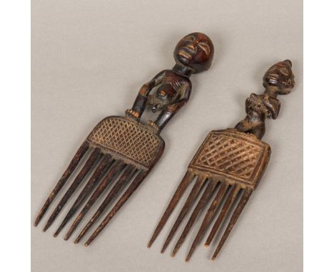 Two African carved and stained wood combsEach figurally mounted.  31 cm and 30 cm long respectively.  (2) CONDITION REPORTS: 