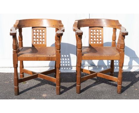 Mouseman: A pair of Robert 'Mouseman' Thompson Oak Monk's chairs, with curved backs and shaped arms, over three lattice patte