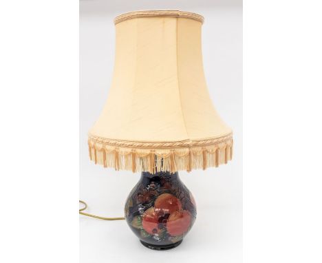 Moorcroft Pottery: A Moorcroft Pottery Pomegranate pattern lamp base and shade. Height of lamp base approx. 24cm. Further Det