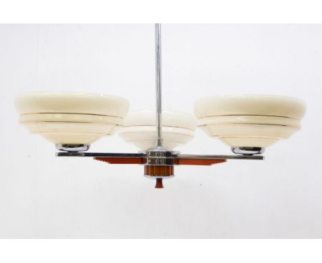 An Art Deco chrome and orange bakelite three-light chandelier (each glass light shades approx. 21.5cm diameter), together wit