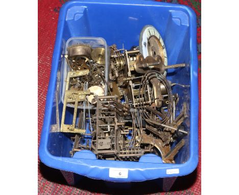 A box of clock movements and spare parts.