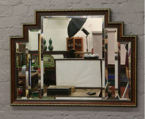 An Art Deco style gilt and burr walnut framed bevel edge wall mirror.