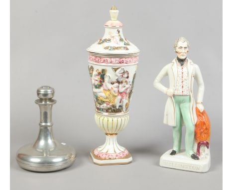 A Wellington Staffordshire figure along with a Capodimonte lidded vase and a pewter decanter.