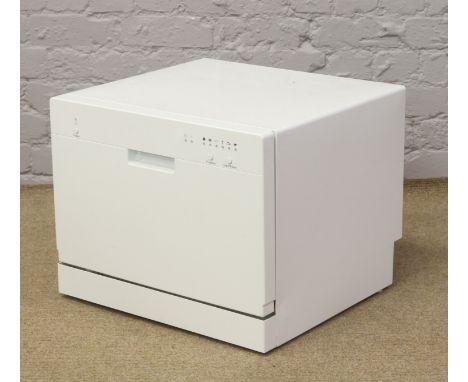 A white compact table top dish washer.