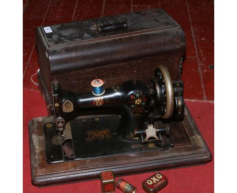 A cased vintage Jones Clus sewing machine.