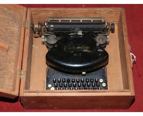 A vintage Empire No. 2 typewriter in pine case.