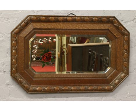 A stepped oak framed bevel edge gypsy mirror.