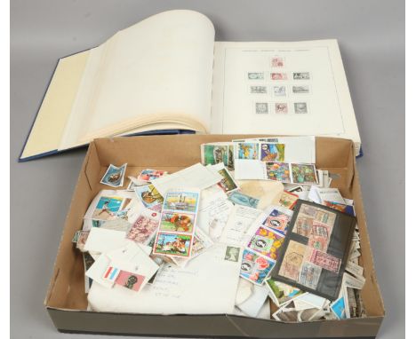 A Schaubek stamp album along with a quantity of loose stamps, first day covers and cigarette cards.