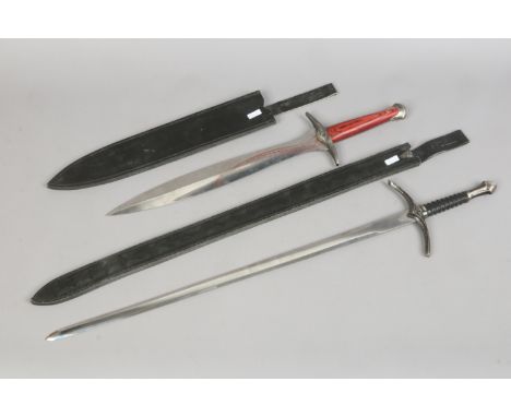 Two decorative Lord of The Rings themed daggers in leather scabbards.