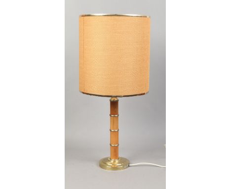 A 1970's table lamp with turned pine pedestal and Hessian shade.