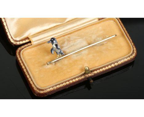 An Edwardian novelty 9ct gold bar brooch set with enamel and mother of pearl formed as a penguin.