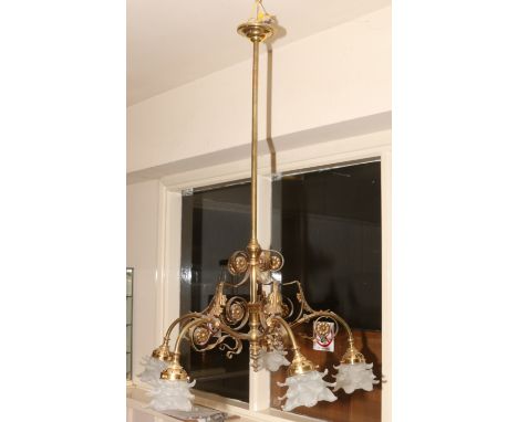 An early 20th century brass five brass ceiling light fitting with milchglas shades formed as flower heads.